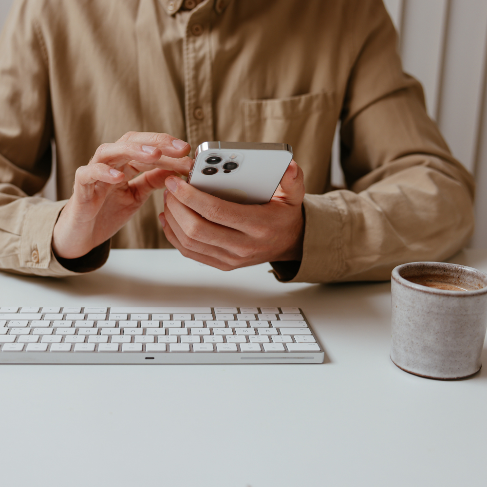 Marketer working on phone at a desk