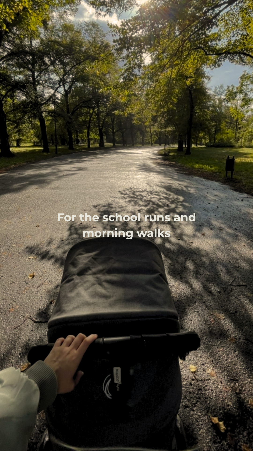 Person pushing a stroller on a tree-lined path with text overlay.