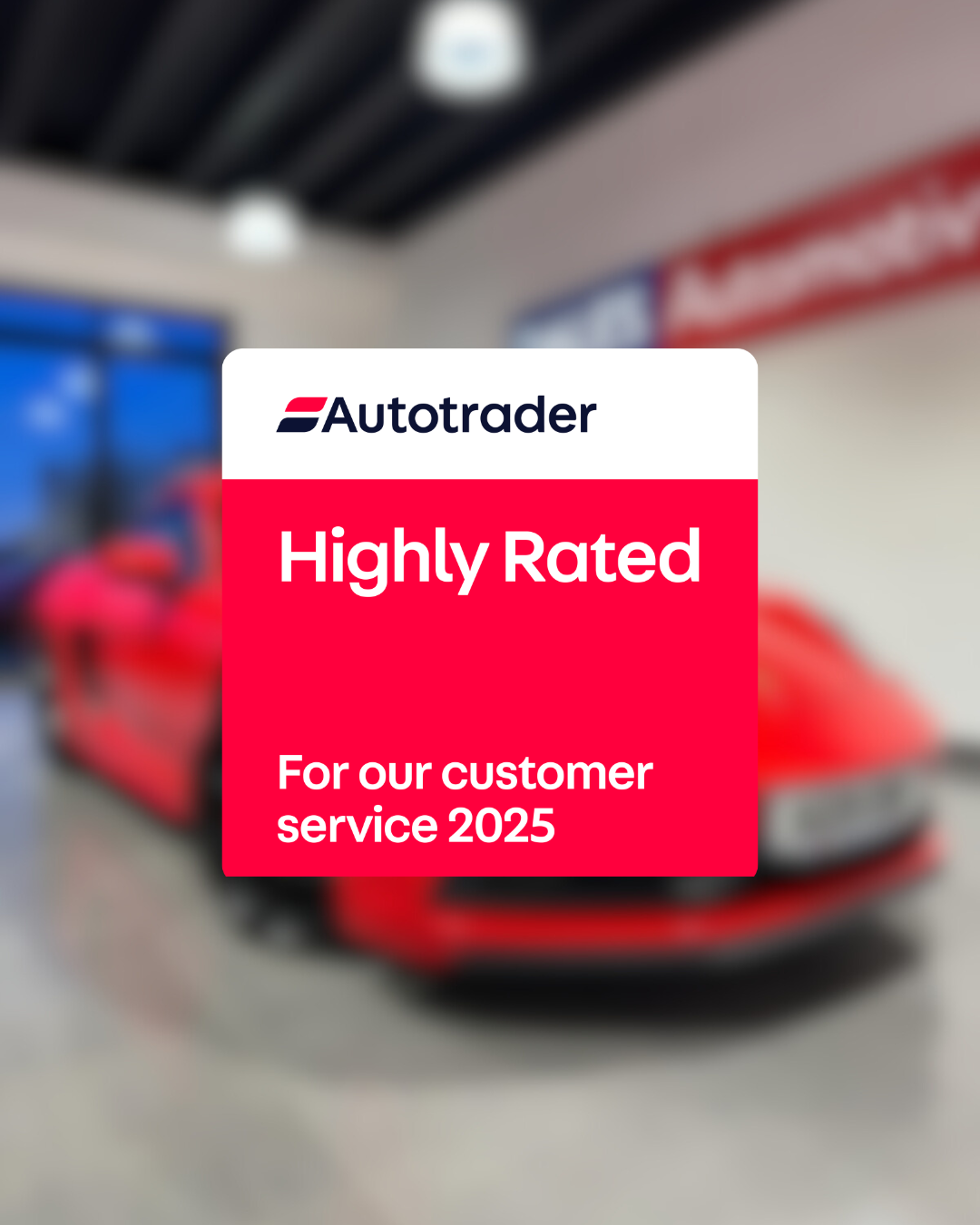 Red car in a garage with Autotrader 'Highly Rated' for customer service 2025 badge.